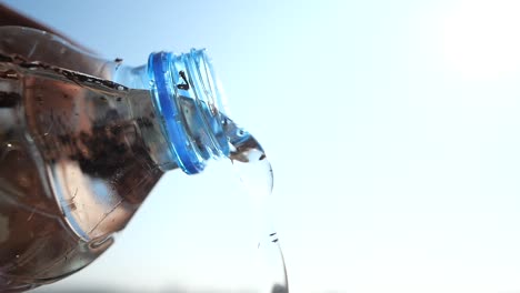 pouring water from a plastic bottle