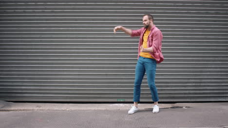 Contemporary-funky-caucasian-man-street-dancer-dancing-freestyle-in-the-city