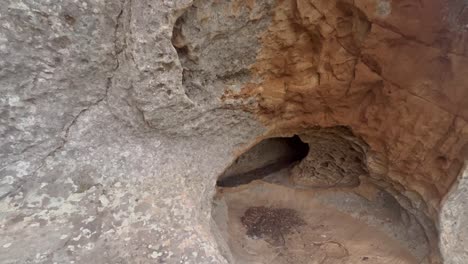 Getting-out-walk-from-inside-the-cave,-stony-and-rocky-surface-of-an-old-time-structure,-raw-natural-ambiance