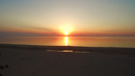 antena: la playa alrededor de la barrera de mareas de tormenta de oosterschelde durante una puesta de sol de verano