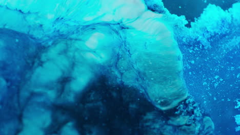dense blue liquid creating an abstract form. macro view