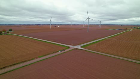 aerial crossroads amidst wind turbines and plowed fields showcase sustainable rural energy, new sharon, iowa