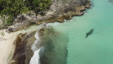 tropical beach playa rincon with white sand and turquoise waters - aerial drone shot