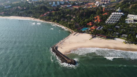 big white waves rooling on the white sand beach near the touristic sealinks beach vietnam on a calm sunny day