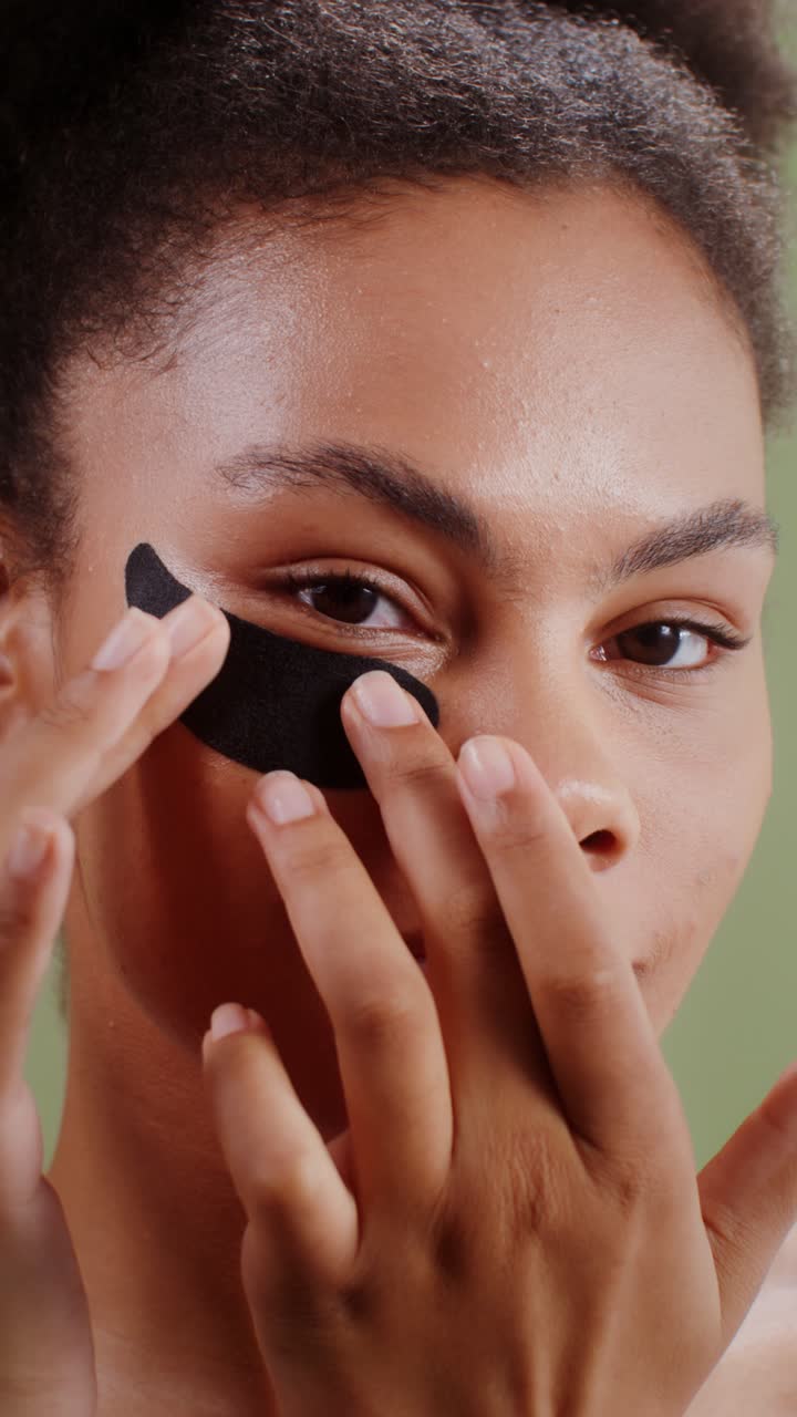 Woman Applying Eye Patch