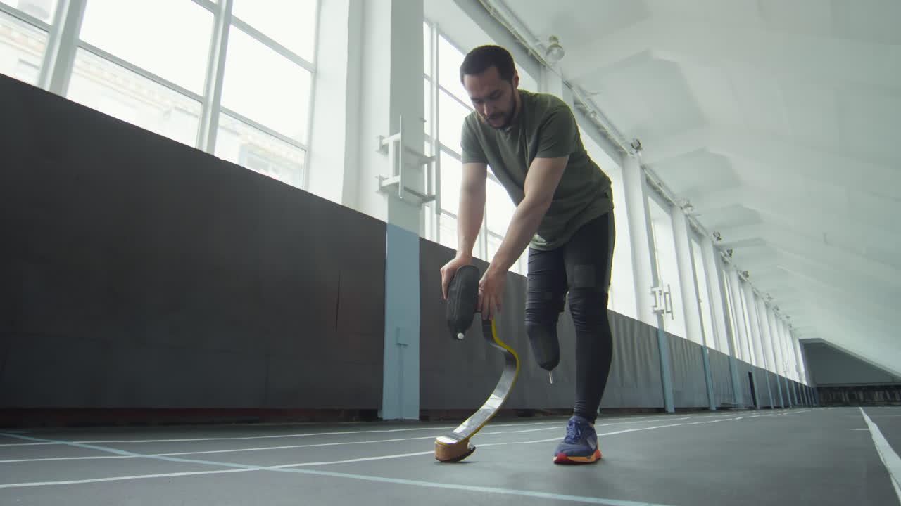 Athlete Putting on Prosthetic Running Blade and Jogging