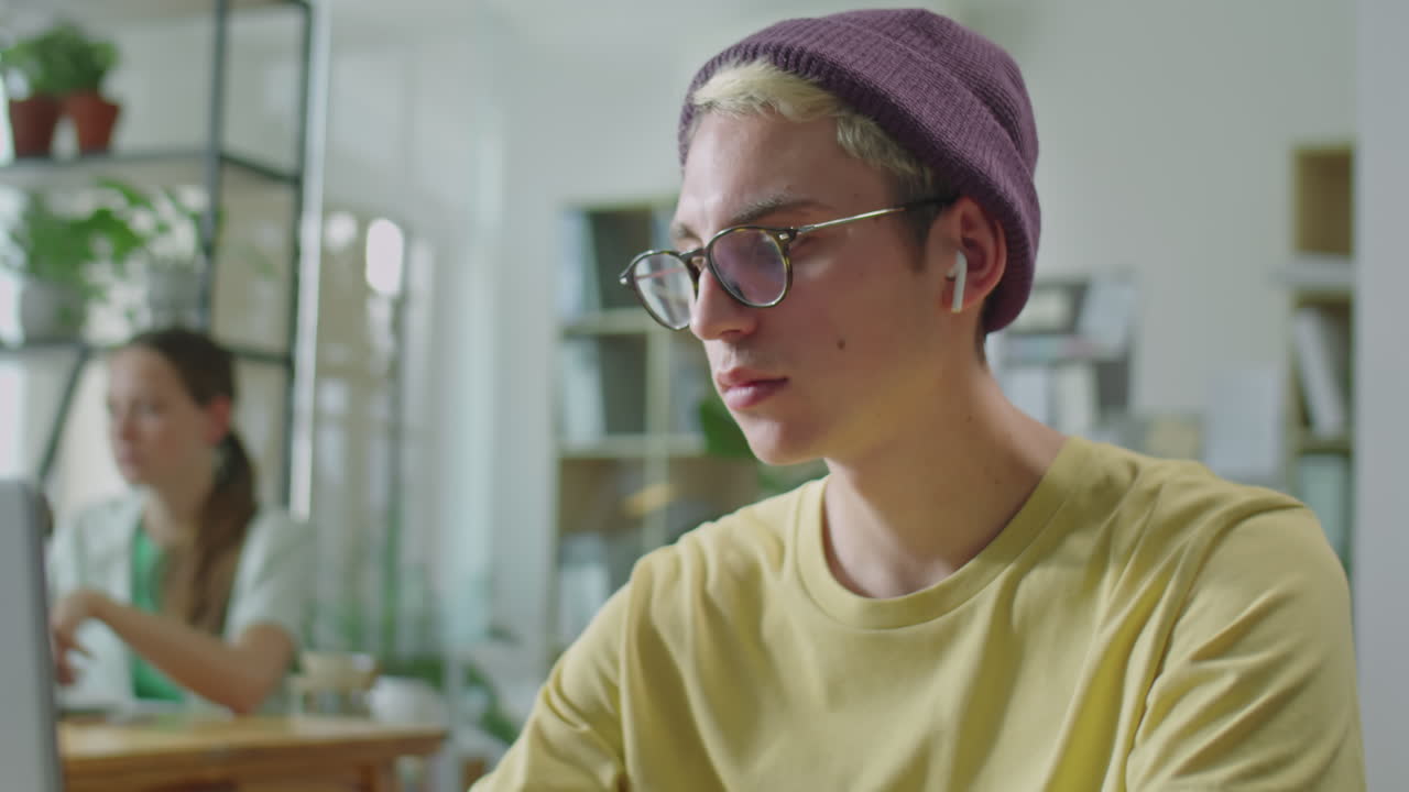 Gen Z Office Worker Using Laptop at Desk