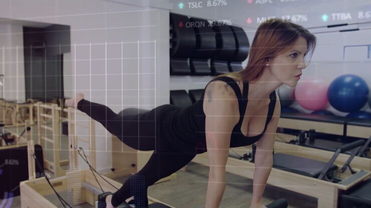 Pilates woman planting hands on reformer initiating leg lifting for core tone, HUD overlay hovering