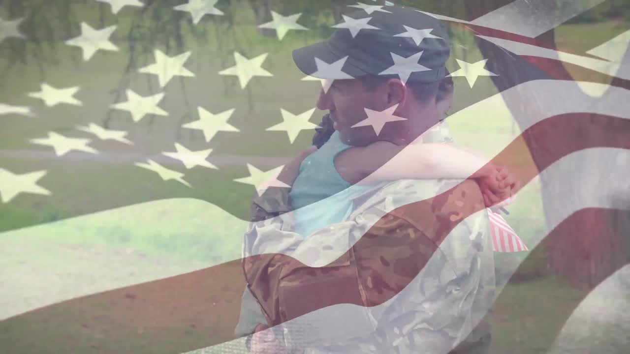 un soldado abrazando a su hija con nuestra bandera en primer plano.
