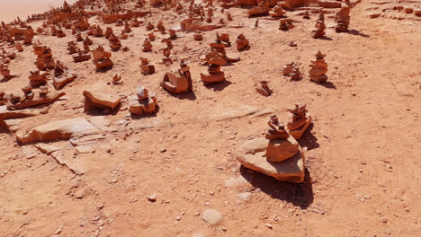 homogenous pattern of stacked rocks spread across as mementos from tourists visiting wadi rum