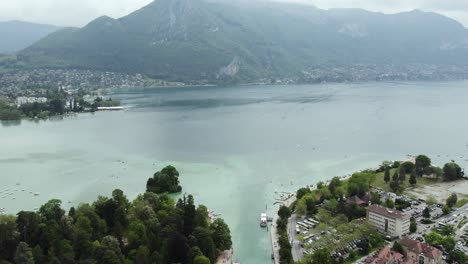 beautiful alpine lake annecy in france mountains, aerial tilt-up establisher