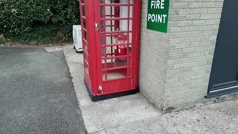 slow motion obsolete british red phone box modified to hold fire safety extinguisher