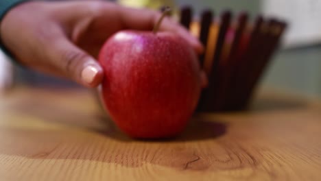 a elective focus shot of a wooden table on the apple focus.