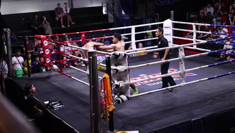 intense muay thai fight in a boxing ring