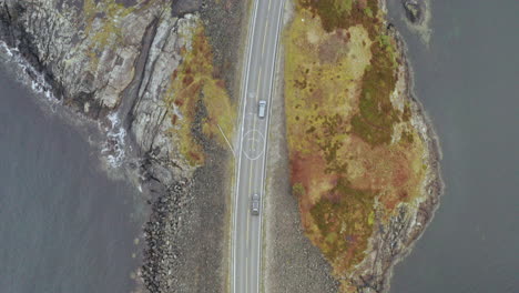 Top-View-Of-Two-Vehicles-Crossing-The-Atlantic-Ocean-Road-in-More-and-Romsdal-County,-Norway