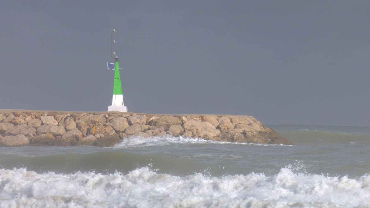 Stormy waves breaking on harbor wall, mediterranean sea, slow motion