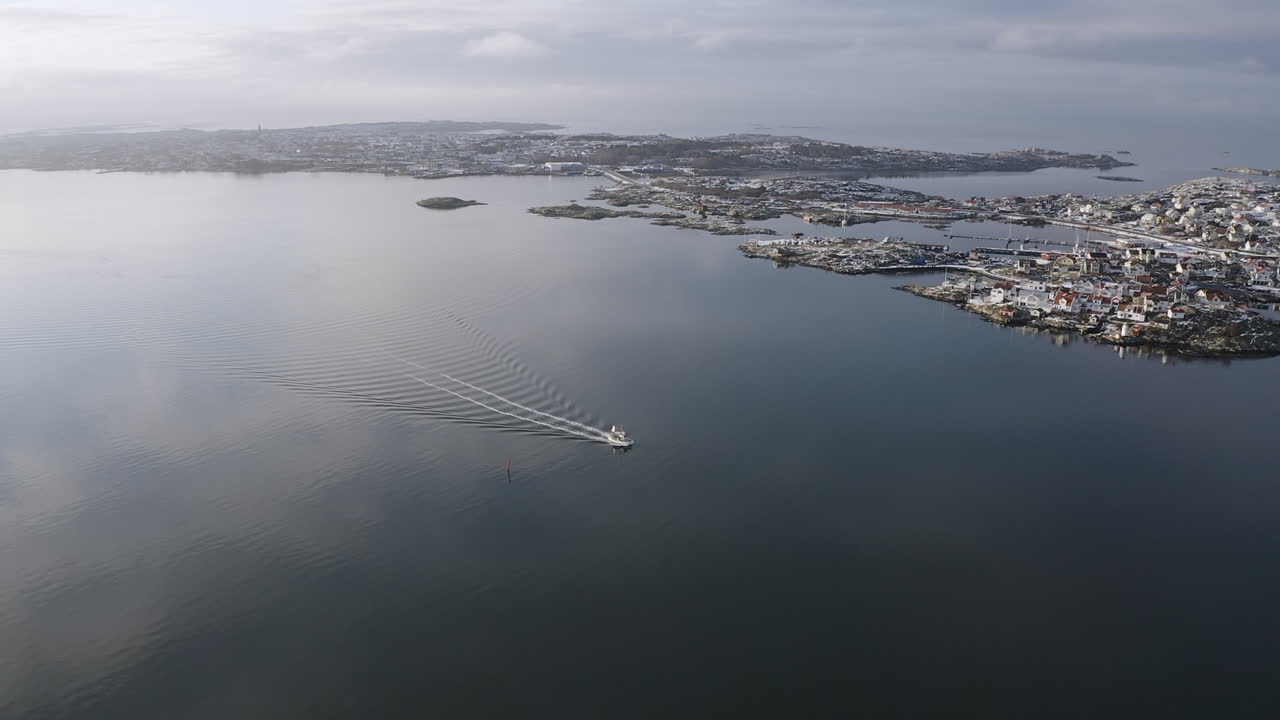 Aerial shot of a small sailboat outside Öckerö Island Municipality in Gothenburg archipelago, Sweden.