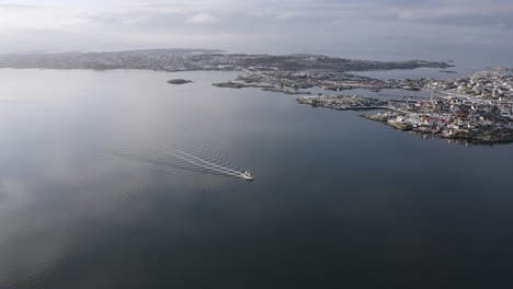 aerial shot of a small sailboat outside öckerö island municipality in gothenburg archipelago, sweden.