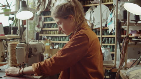 Portrait-of-Young-Woman-at-Desk-in-Shoemakers-Workshop