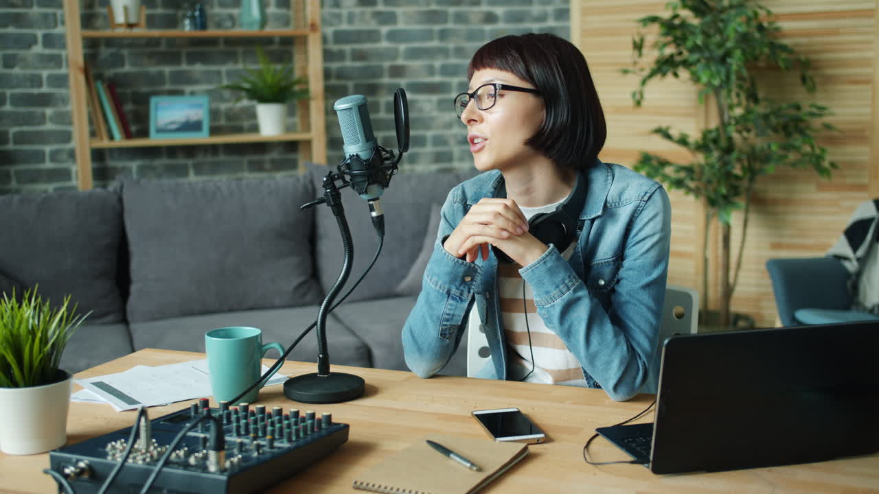 Woman recording a podcast in a home studio