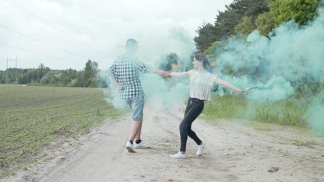 couple with colored smoke circling on dusty road