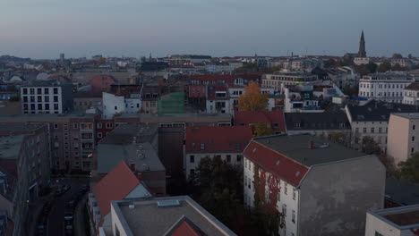 Fly-above-residential-buildings-in-broader-city-centre,-blocks-of-apartment-houses-at-dusk.-Berlin,-Germany