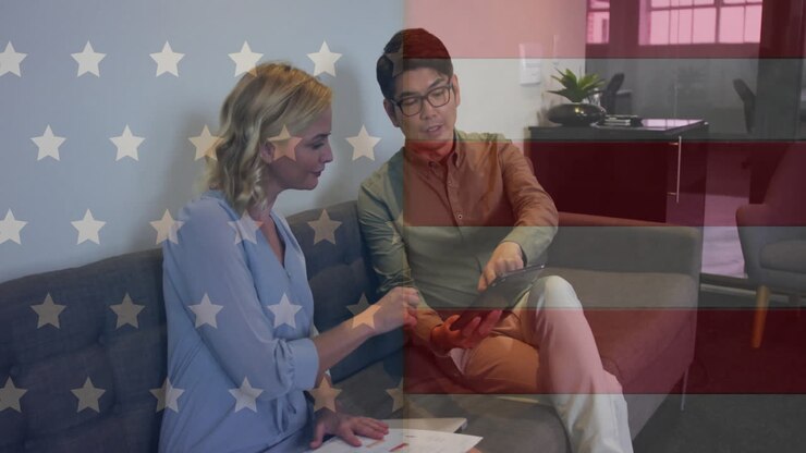 Animation of flag of usa over diverse business people in office