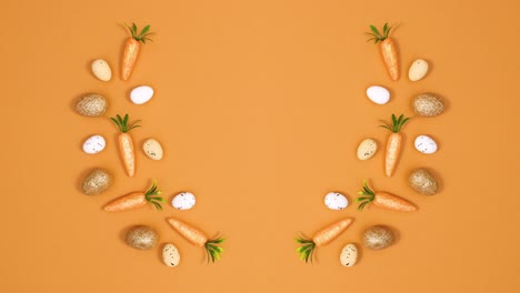 creative easter composition made of eggs and carrots on orange background with copy space. stop motion