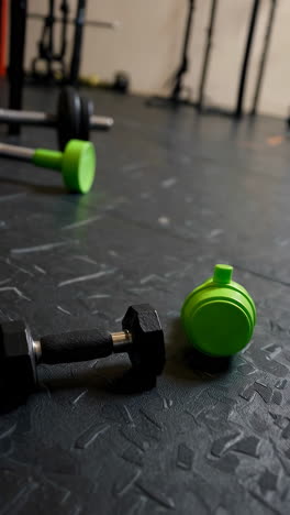 gym floor with dumbbells and kettlebells