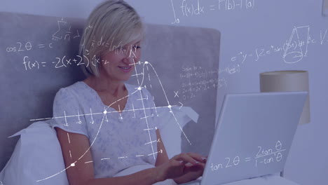 Mathematical-equations-and-graphs-animation-over-woman-using-laptop-in-bed