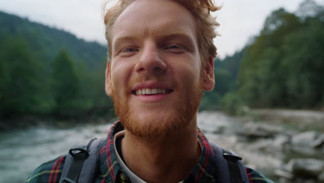 Hiker-standing-in-mountain-landscape.-Redhead-man-looking-at-camera-outdoor