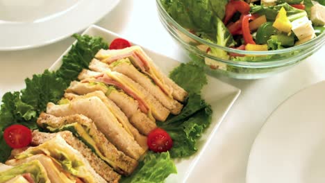 view of a table buffet with plates of sandwiches