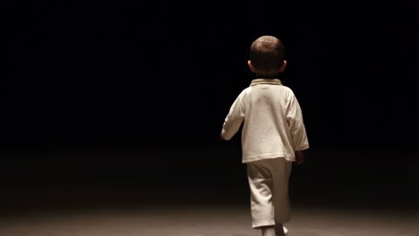a young child walks into a dark, unknown space