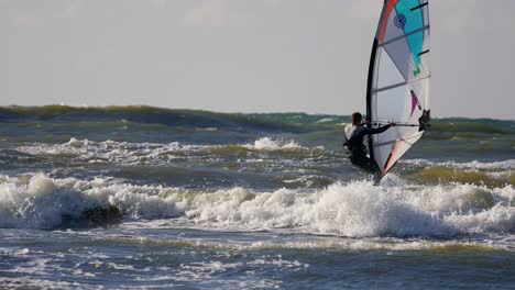 windsurfing on high waves of baltic sea, poland