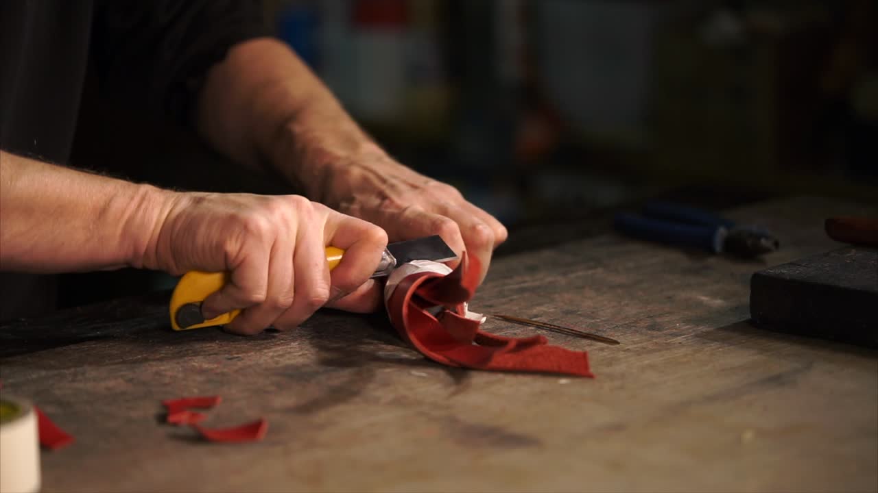 Leather Craftsman Working on Red Leather