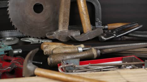 various old tools lie on a wooden rack