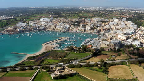 panoramic view of marsaxlokk fishing village in the south eastern region of malta - aerial drone shot