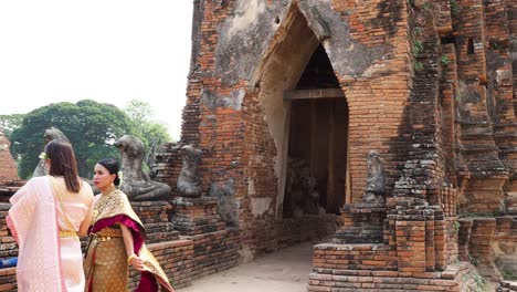 women in traditional attire at ancient temple site