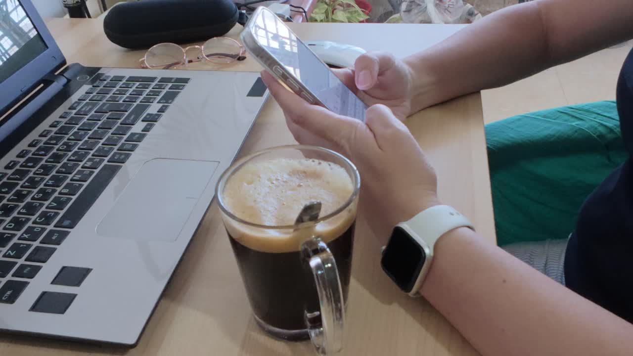 Detailed close-up of hands holding and using a smartphone