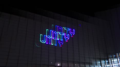 laser-show-that-beams-messages-of-'peace,'-'love,'-and-'unity'-onto-a-beautiful-wall-of-art-exhibition-building-Immersive-in-a-colourful-display-while-being-reminded-of-positive-messages