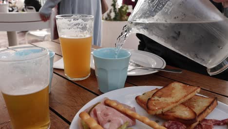 water being poured into a cup outdoors