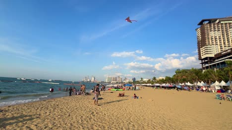 pattaya thailand beach day time, group of people beachfront sandy shore
