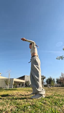 young woman dancing a choreography outdoors