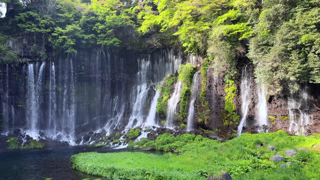 A serene view of Shiraito Falls near Mount Fuji, showcasing cascading waterfalls