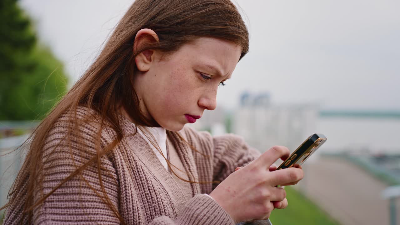 밖에서 스마트폰을 사용하는 십대 소녀