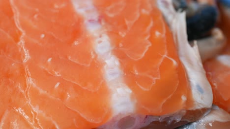 raw, fresh salmon steak on a plastic packet on table ,