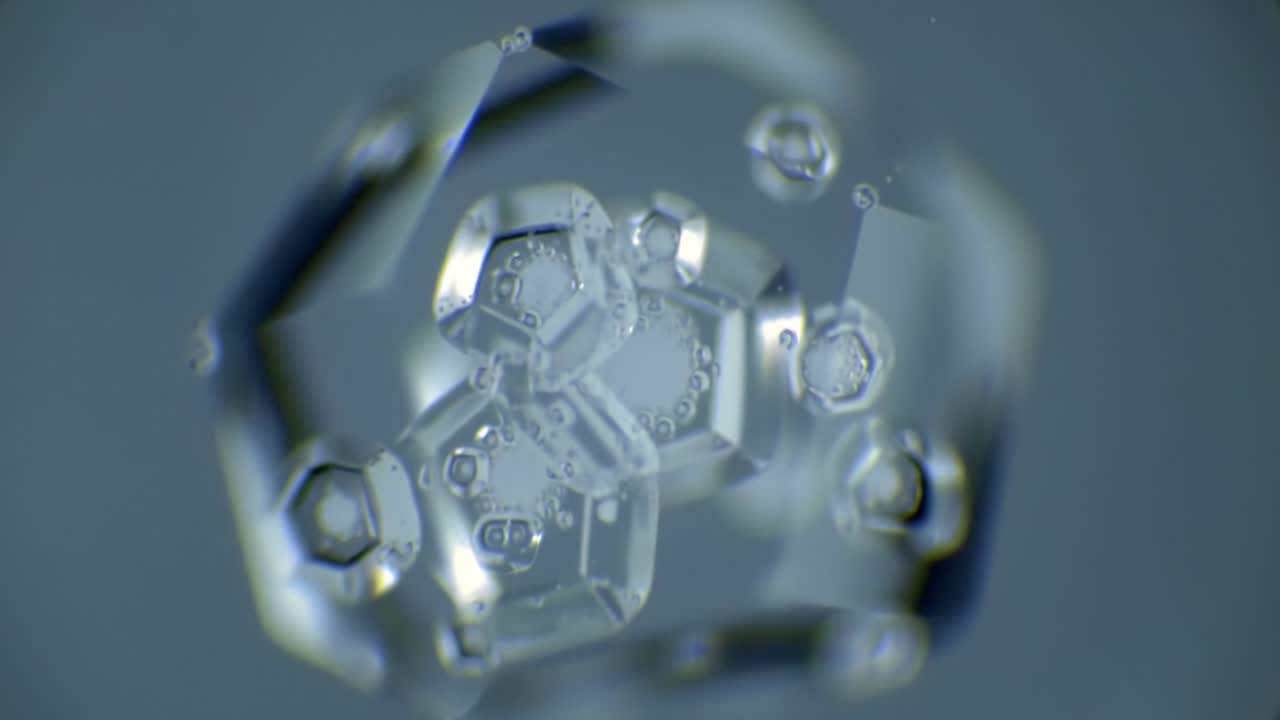 Stunning Microscopic Images of Crystalline Structures Displaying Intricate Designs and Captivating Light Reflections in a Blue Background