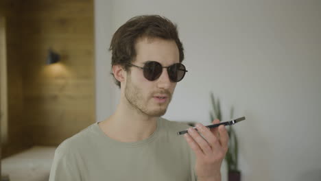 close-up view of young blind man talking on the phone