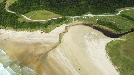 Idyllic-camping-site-by-river-at-Parakaunui-bay,-New-Zealand,-aerial