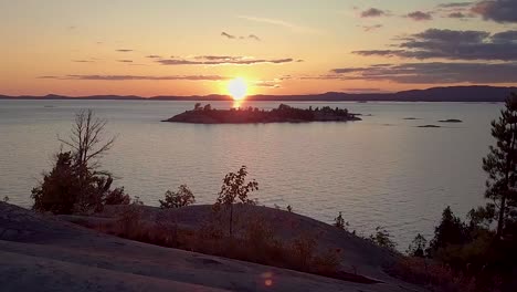 flying over smooth granite boulders at sunset, drone aerial wide dolly in